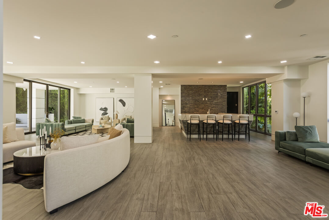 4230 Valley Meadow Road Encino, CA 91436 - Photo 27 of 44 a living room with furniture and wooden floor