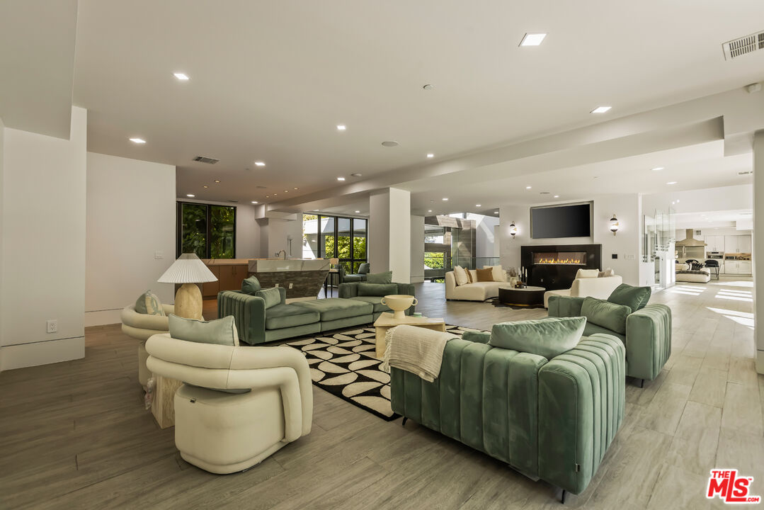 4230 Valley Meadow Road Encino, CA 91436 - Photo 29 of 44 a living room with furniture and a flat screen tv