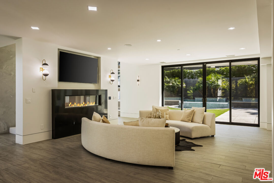 4230 Valley Meadow Road Encino, CA 91436 - Photo 30 of 44 a living room with fireplace furniture and a flat screen tv