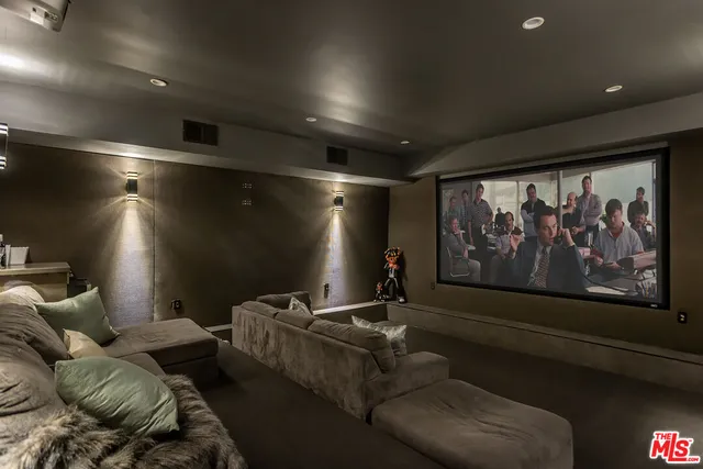 a media room with furniture and screen