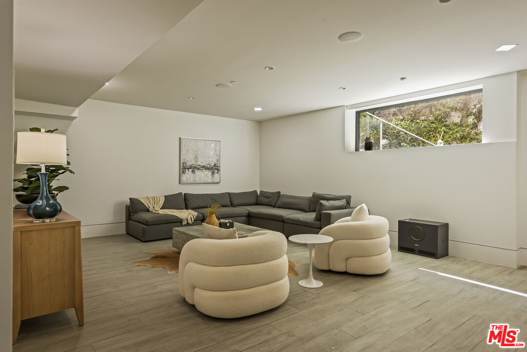4230 Valley Meadow Road Encino, CA 91436 - Photo 32 of 44 a living room with furniture and wooden floor