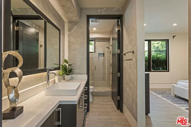 a bathroom with a tub sink and mirror