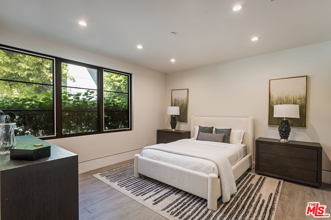 4230 Valley Meadow Road Encino, CA 91436 - Photo 36 of 44 a bedroom with a large bed and a large window