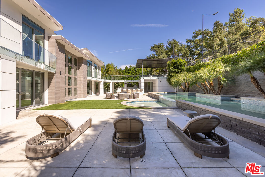 4230 Valley Meadow Road Encino, CA 91436 - Photo 38 of 44 a swimming pool with outdoor seating and yard