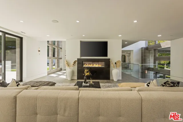 a living room with fireplace furniture and a flat screen tv