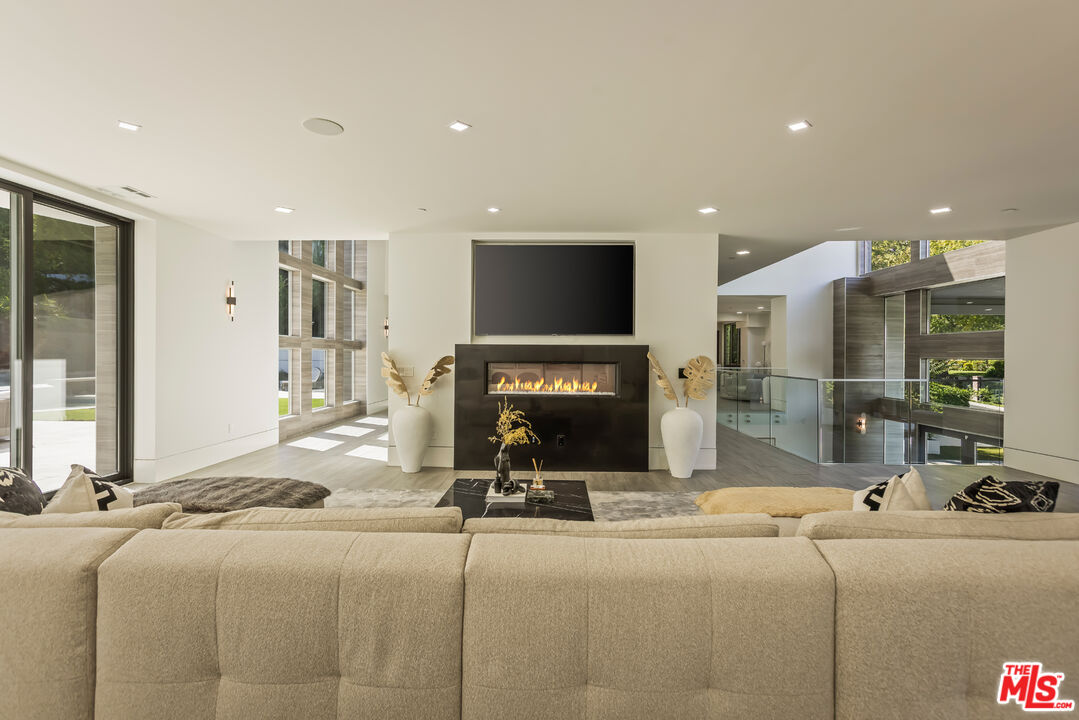 4230 Valley Meadow Road Encino, CA 91436 - Photo 6 of 44 a living room with fireplace furniture and a flat screen tv