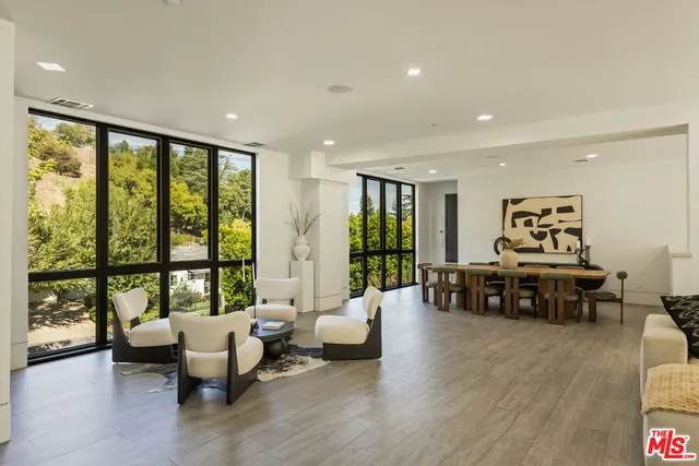 a living room with furniture and large windows