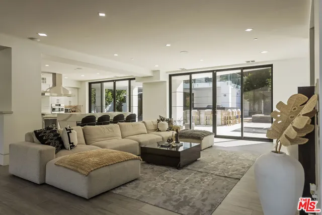 a living room with furniture and a floor to ceiling window