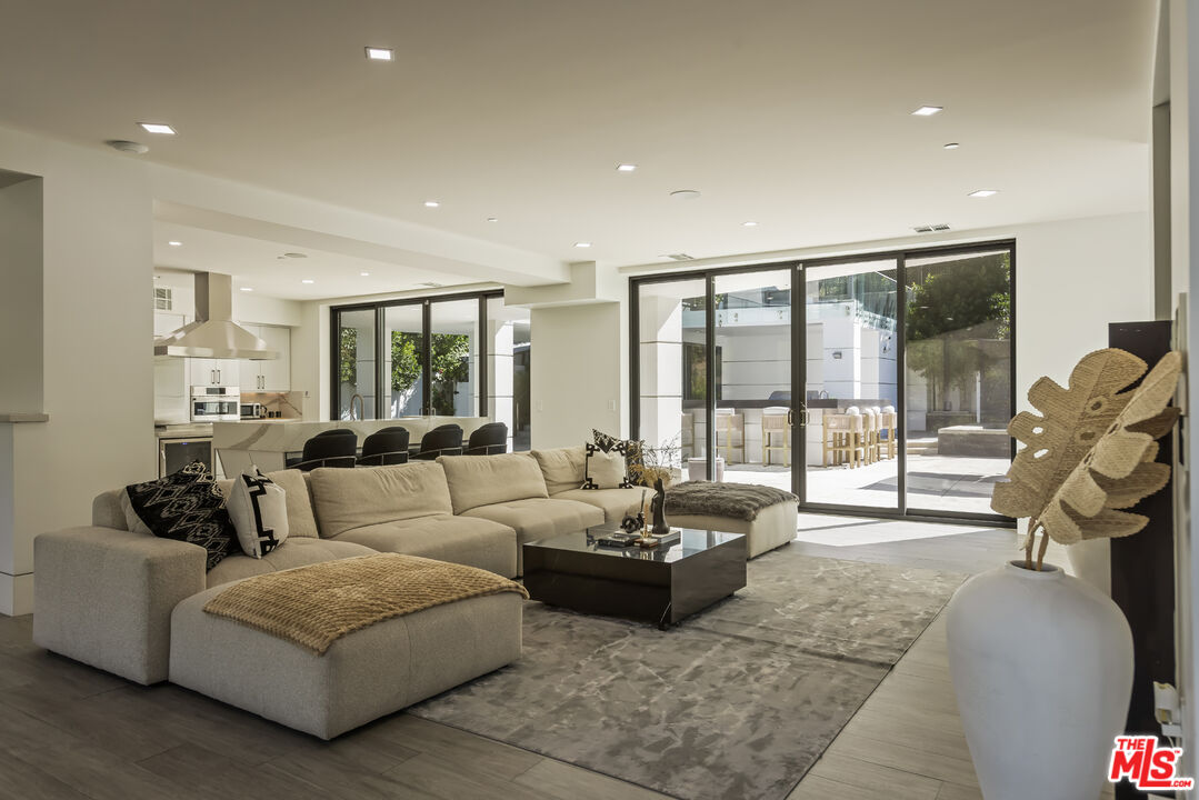 4230 Valley Meadow Road Encino, CA 91436 - Photo 9 of 44 a living room with furniture and a floor to ceiling window