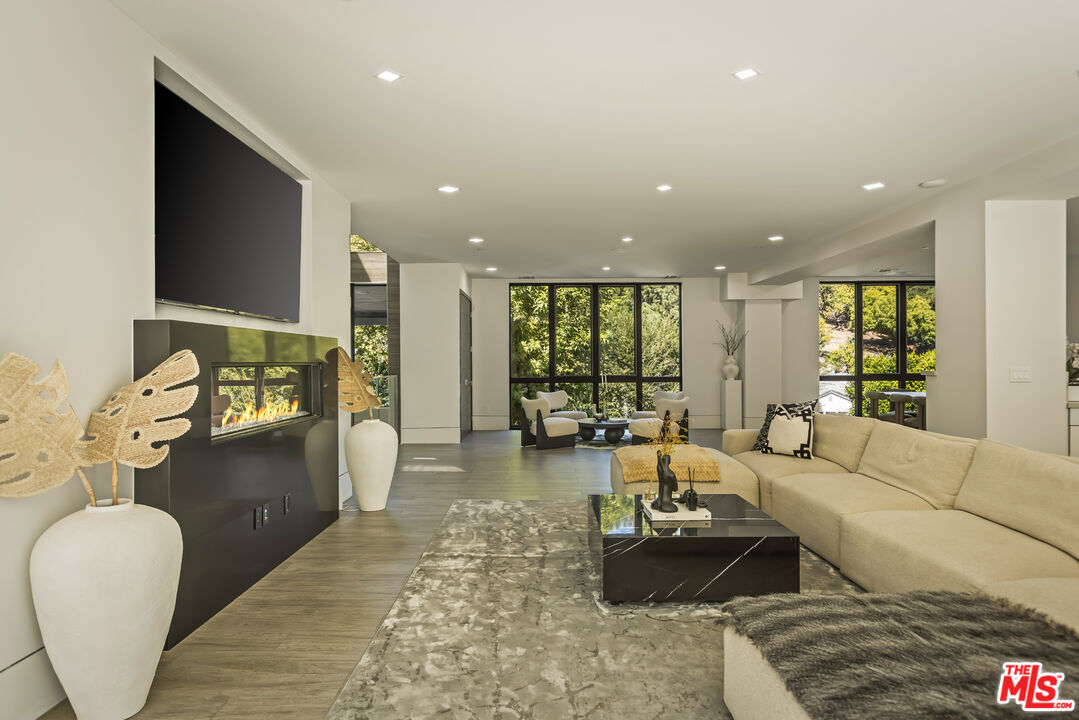 4230 Valley Meadow Road Encino, CA 91436 - Photo 10 of 44 a living room with furniture and a flat screen tv