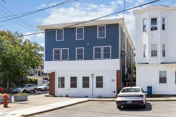 a car parked in front of a brick building