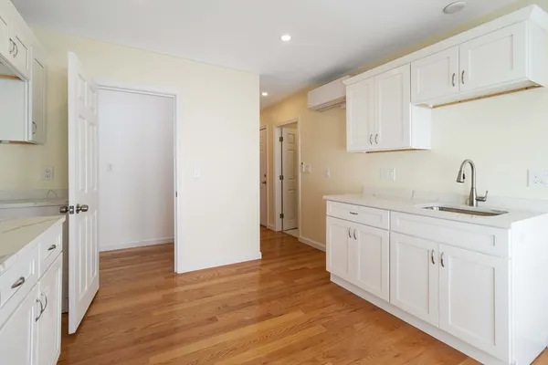 a spacious bathroom with a sink and a mirror