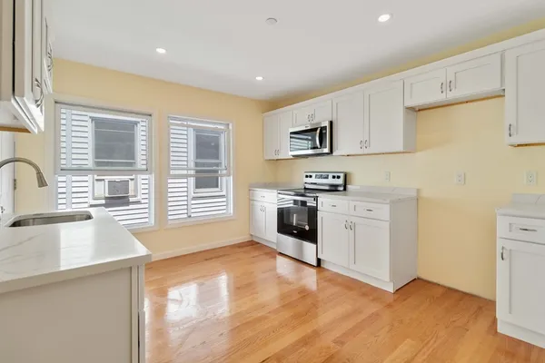 a kitchen with stainless steel appliances a stove sink and cabinets
