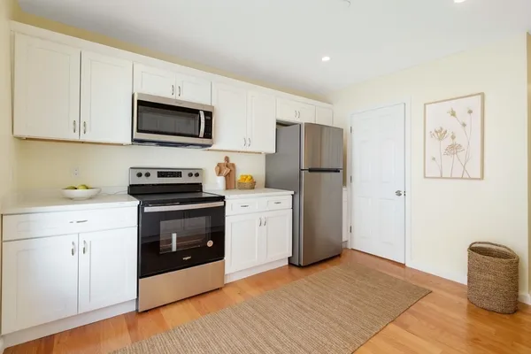 a kitchen with stainless steel appliances a refrigerator stove and microwave