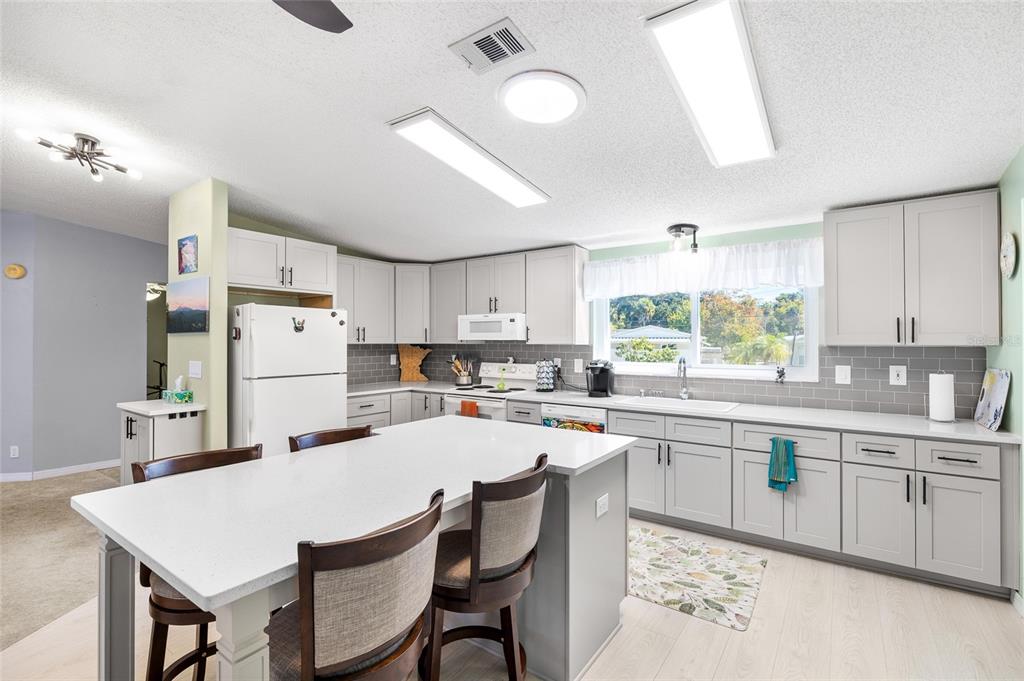 6333 Bear Trail Weeki Wachee, FL 34607 - Photo 11 of 52 a kitchen with appliances a sink and cabinets