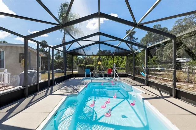a living room with furniture a window a rug and a floor to ceiling window
