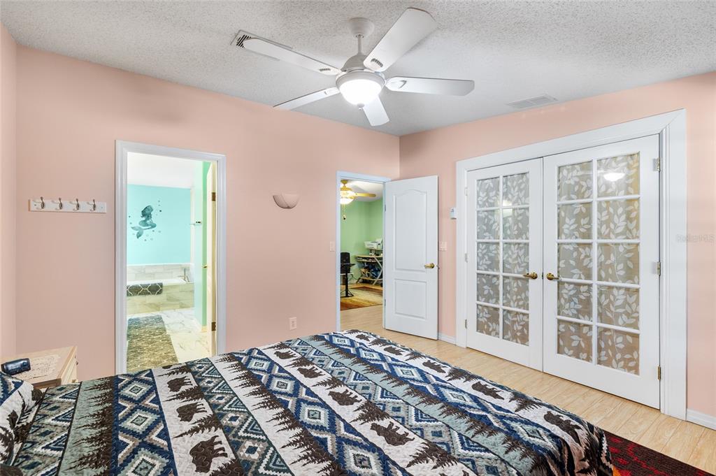 6333 Bear Trail Weeki Wachee, FL 34607 - Photo 15 of 52 a bedroom with a bed and a large window