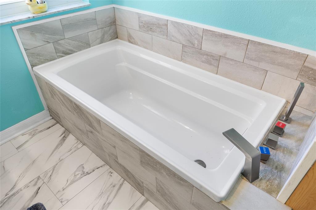 6333 Bear Trail Weeki Wachee, FL 34607 - Photo 16 of 52 a white bath tub sitting in a bathroom