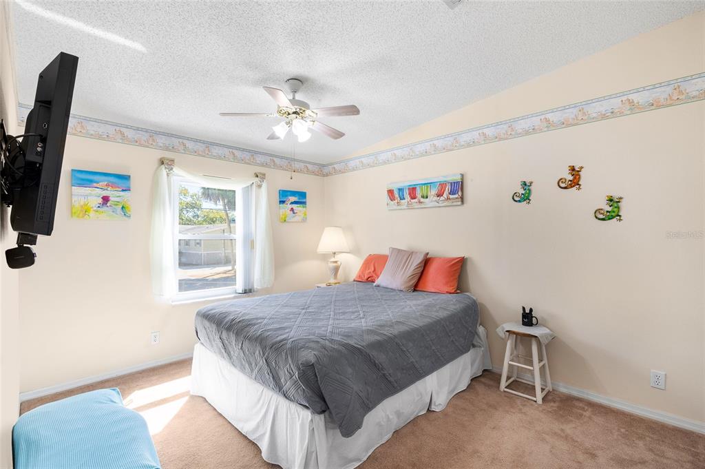 6333 Bear Trail Weeki Wachee, FL 34607 - Photo 18 of 52 a bedroom with a bed and a flat screen tv