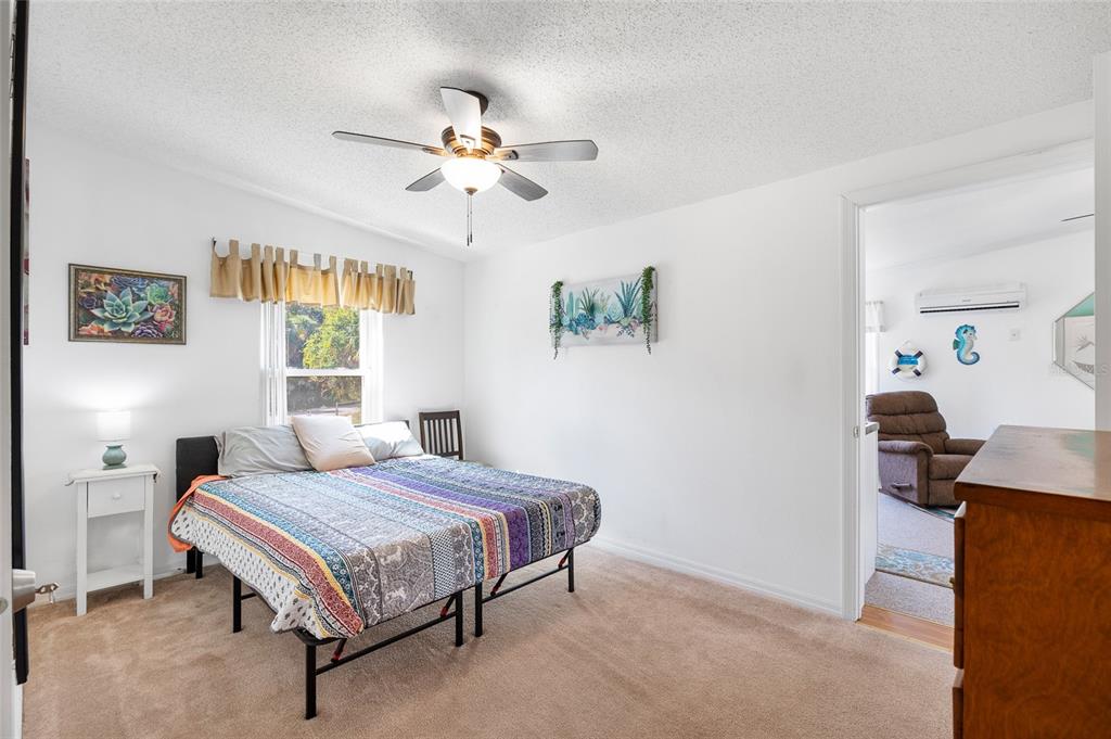 6333 Bear Trail Weeki Wachee, FL 34607 - Photo 19 of 52 a bedroom with a bed and a chandelier