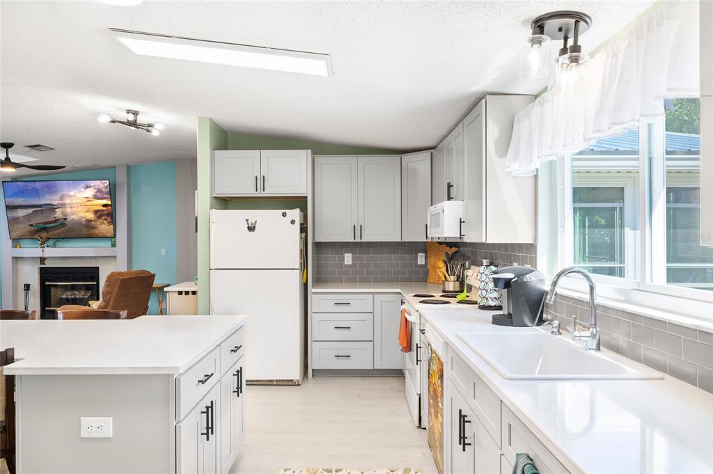 6333 Bear Trail Weeki Wachee, FL 34607 - Photo 20 of 52 a kitchen with a sink a stove a refrigerator and a refrigerator