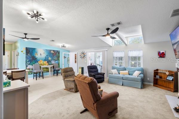 6333 Bear Trail Weeki Wachee, FL 34607 - Photo 24 of 52 a living room with furniture ceiling fan and a chandelier
