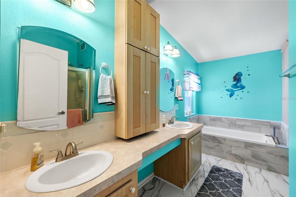 6333 Bear Trail Weeki Wachee, FL 34607 - Photo 25 of 52 a bathroom with a granite countertop sink and a mirror