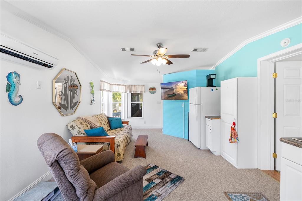 6333 Bear Trail Weeki Wachee, FL 34607 - Photo 28 of 52 a living room with furniture a clock and a window