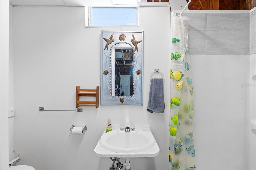 6333 Bear Trail Weeki Wachee, FL 34607 - Photo 32 of 52 a bathroom with a sink and a mirror