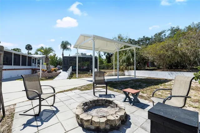 a view of a patio with a table and chairs and potted plants