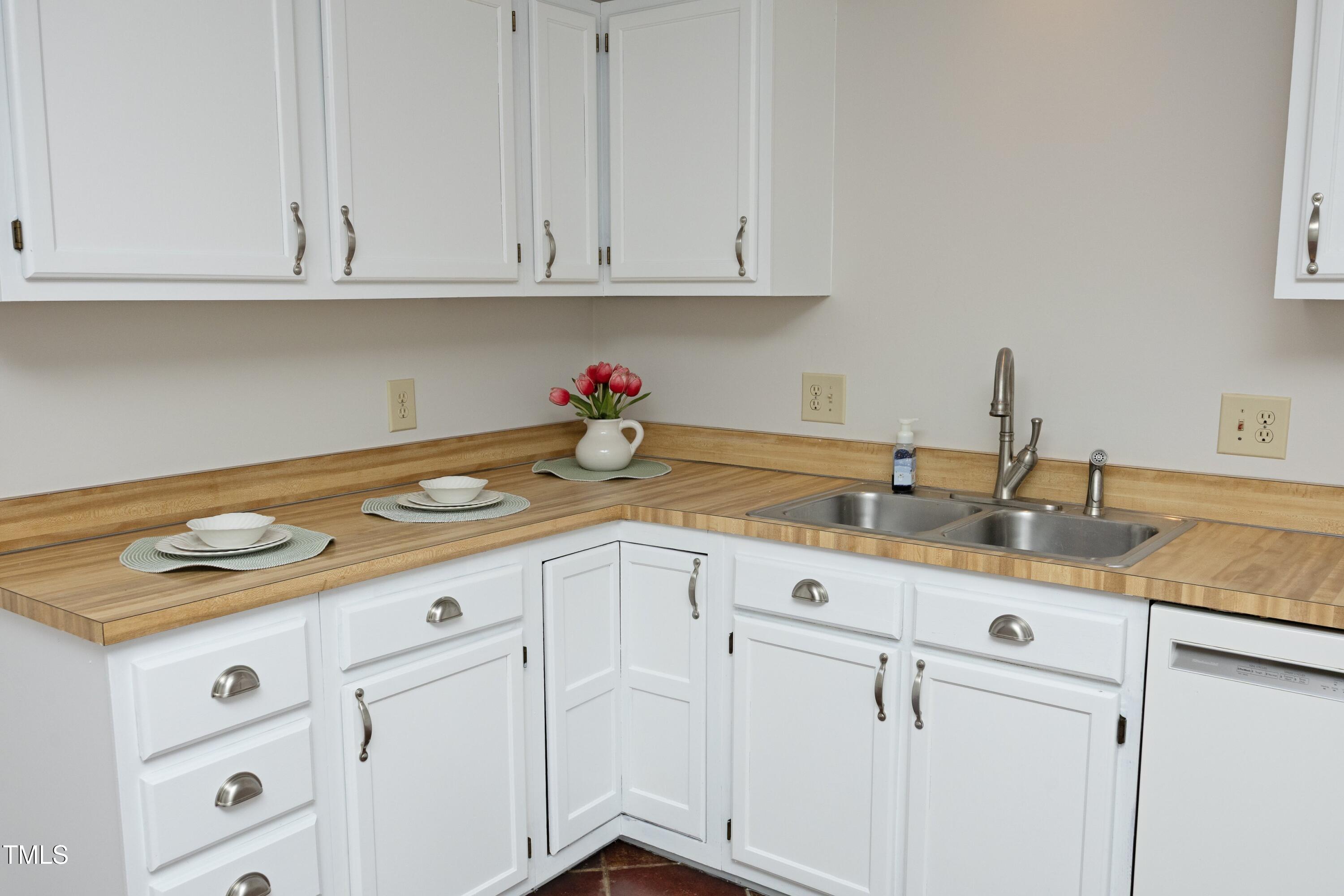 716 Red Forest Trail Raleigh, NC 27615 - Photo 7 of 23 a kitchen with white cabinets and a sink
