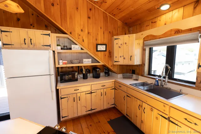 a kitchen with a sink and a refrigerator