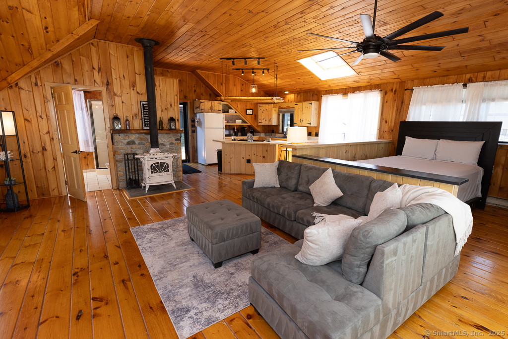 48 Swan Avenue, Unit A Old Lyme, CT 06371 - Photo 13 of 22 a living room with furniture and a chandelier