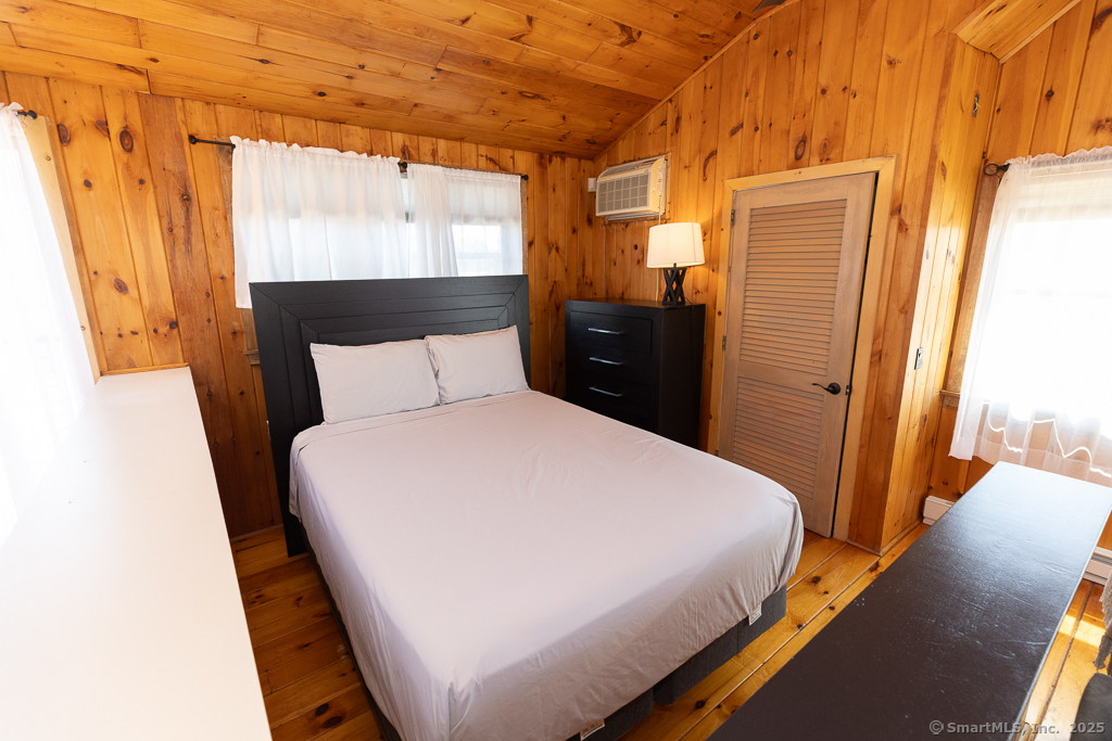 48 Swan Avenue, Unit A Old Lyme, CT 06371 - Photo 14 of 22 a bedroom with a bed and wooden floor