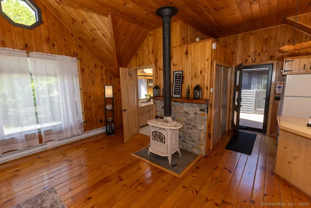 a living room with furniture a large window with wooden floor