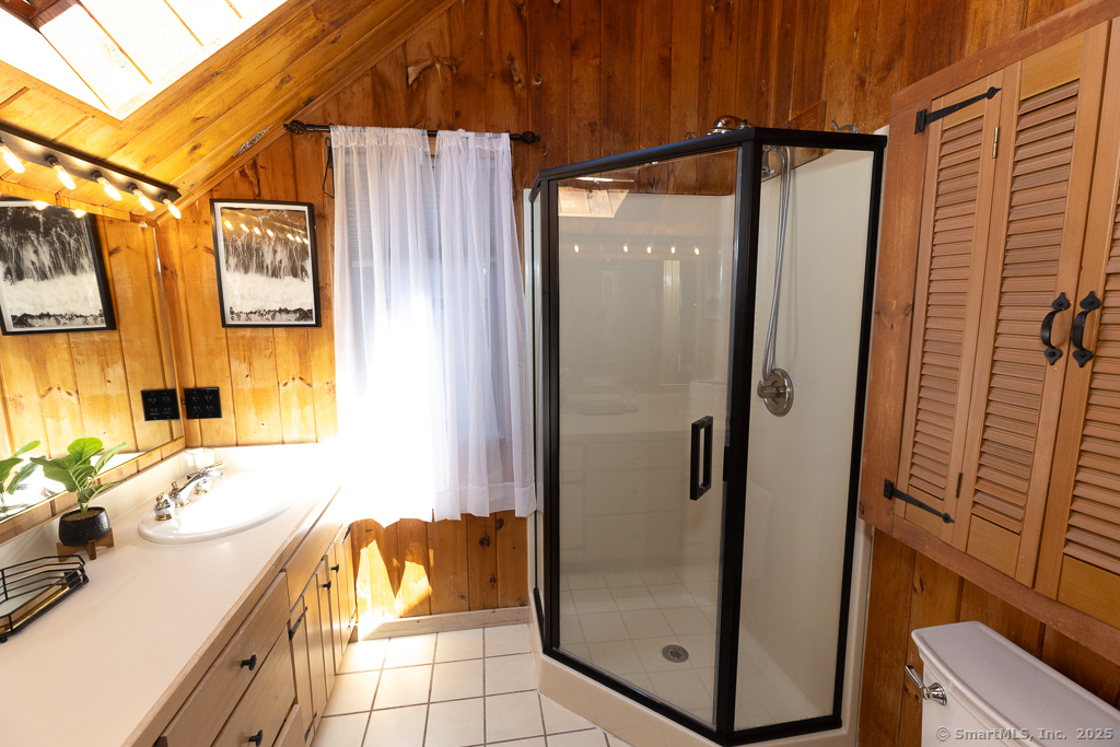 48 Swan Avenue, Unit A Old Lyme, CT 06371 - Photo 19 of 22 a bathroom with a tub and shower