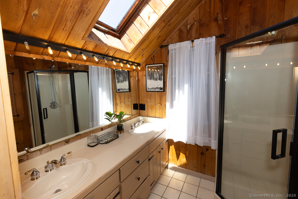 48 Swan Avenue, Unit A Old Lyme, CT 06371 - Photo 20 of 22 a bathroom with a sink and a mirror
