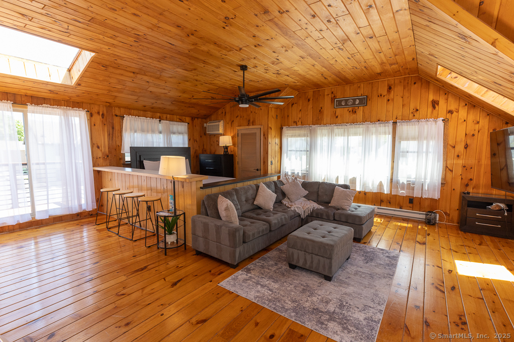 48 Swan Avenue, Unit A Old Lyme, CT 06371 - Photo 21 of 22 a living room with furniture and a large window
