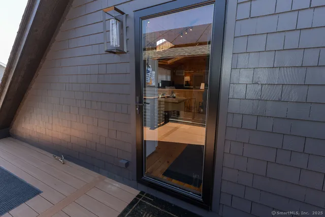 a bathroom with a glass shower door and mirror