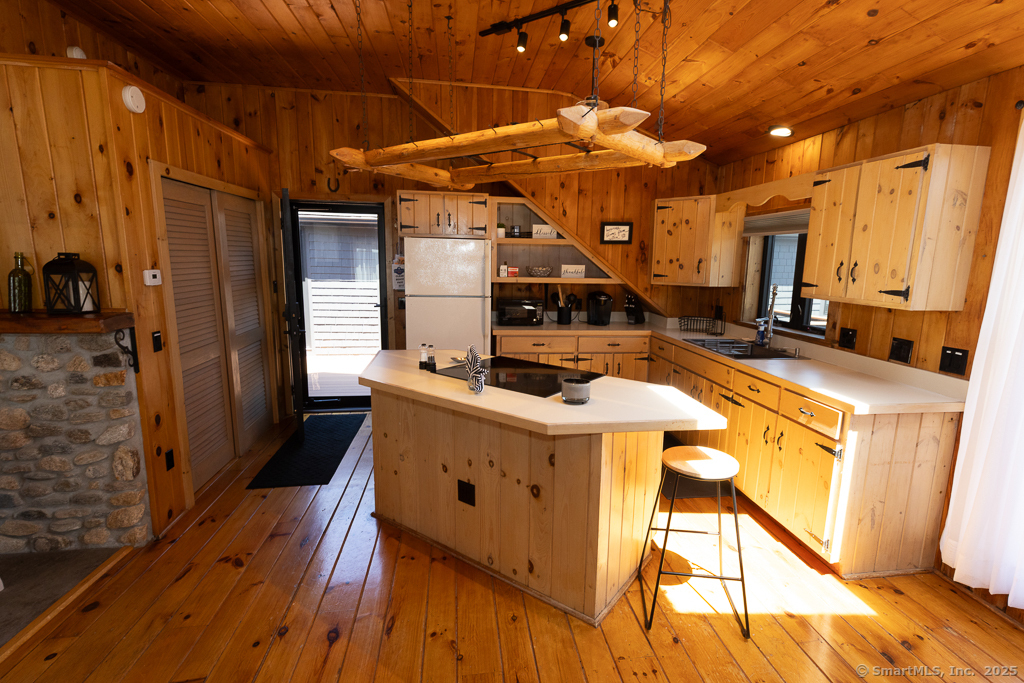 48 Swan Avenue, Unit A Old Lyme, CT 06371 - Photo 8 of 22 a kitchen with stainless steel appliances granite countertop a stove a sink dishwasher and a refrigerator with wooden floor