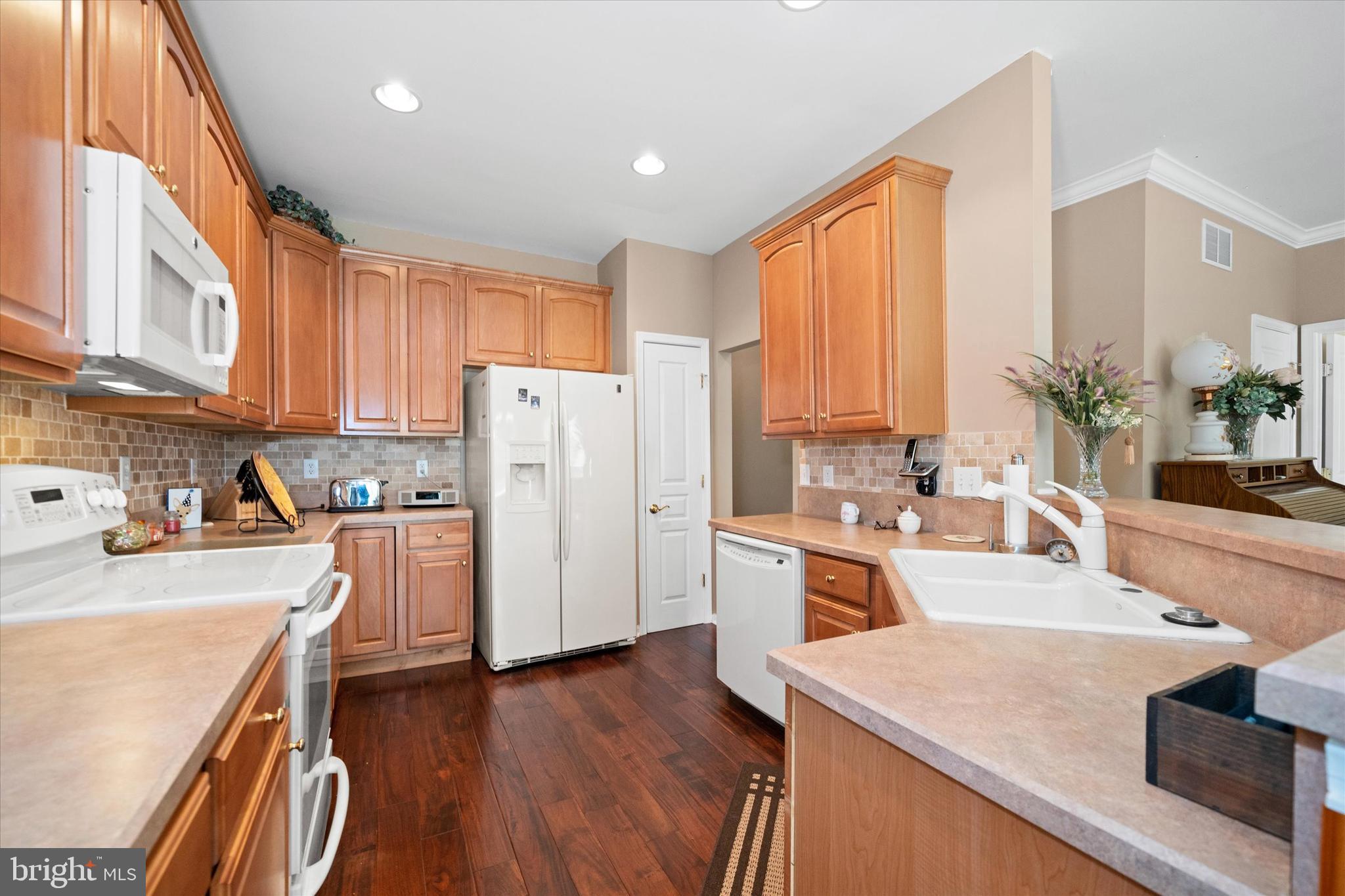 4 Compass Rose Way Newark, DE 19702 - Photo 11 of 28 a kitchen with a refrigerator a stove a sink dishwasher and white cabinets with wooden floor