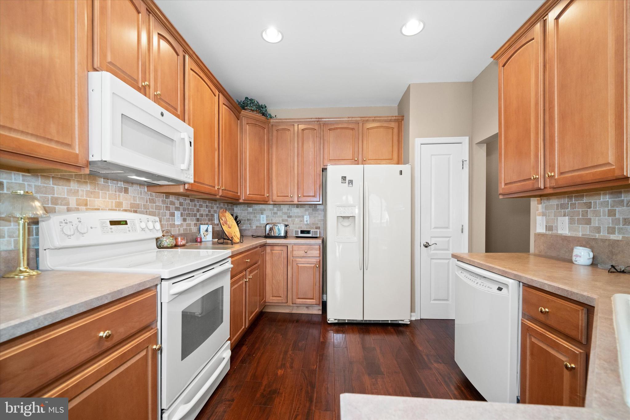4 Compass Rose Way Newark, DE 19702 - Photo 12 of 28 a kitchen with a sink a refrigerator a stove and cabinets