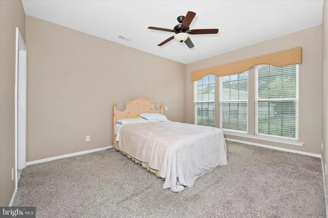 a spacious bedroom with a large bed and a large window