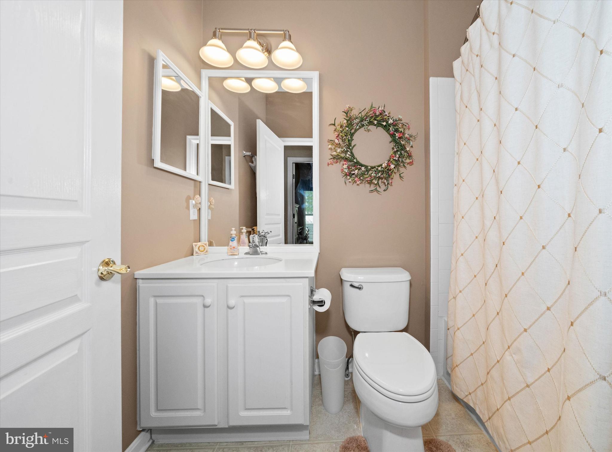 4 Compass Rose Way Newark, DE 19702 - Photo 21 of 28 a bathroom with a toilet a sink and mirror