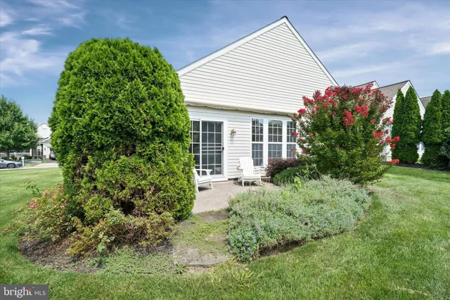 a view of backyard with potted plants and a bench