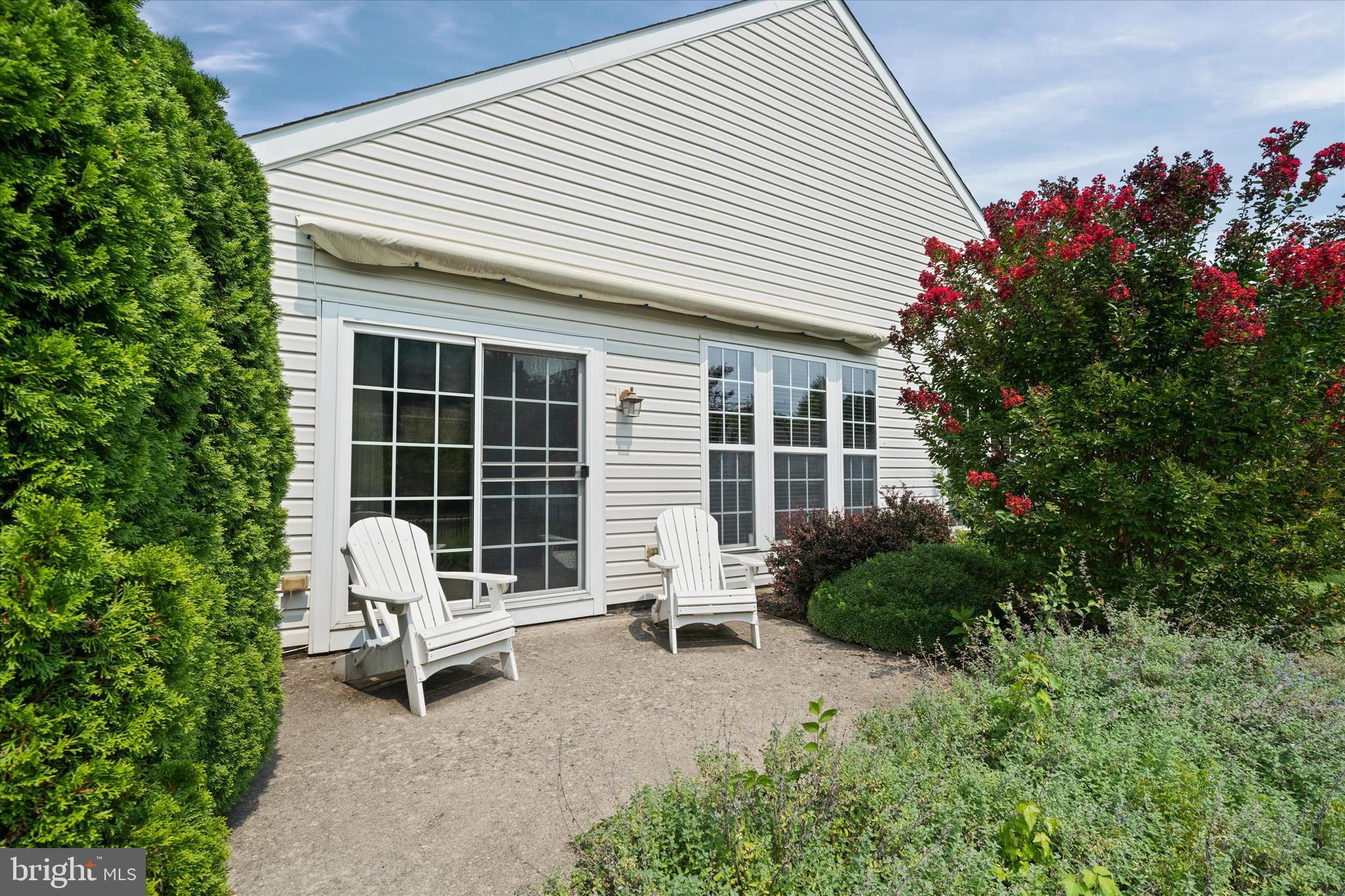 4 Compass Rose Way Newark, DE 19702 - Photo 28 of 28 a white house with table and chairs in front of it