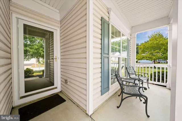 a view of a balcony with furniture and a gate