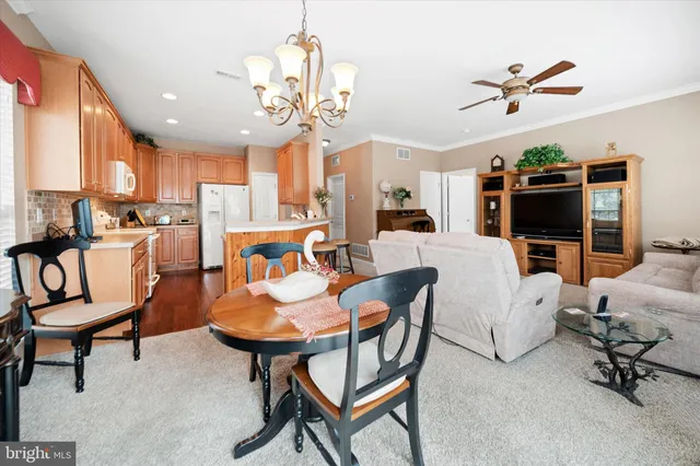 a living room with furniture or chandelier and a window
