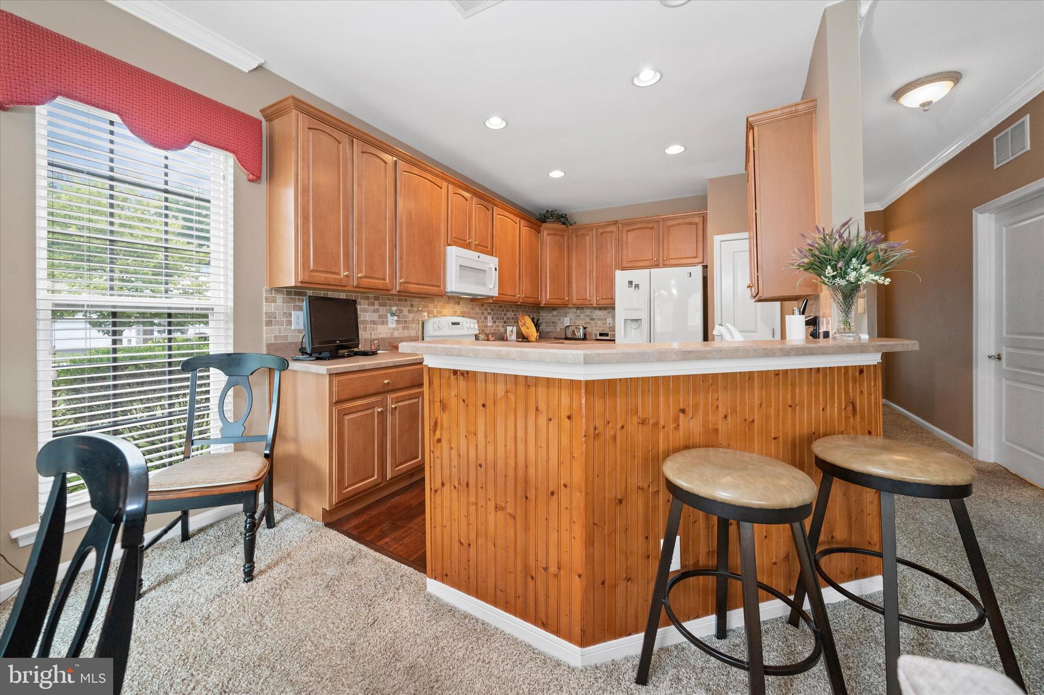 4 Compass Rose Way Newark, DE 19702 - Photo 10 of 28 a kitchen with stainless steel appliances granite countertop table chairs sink and window