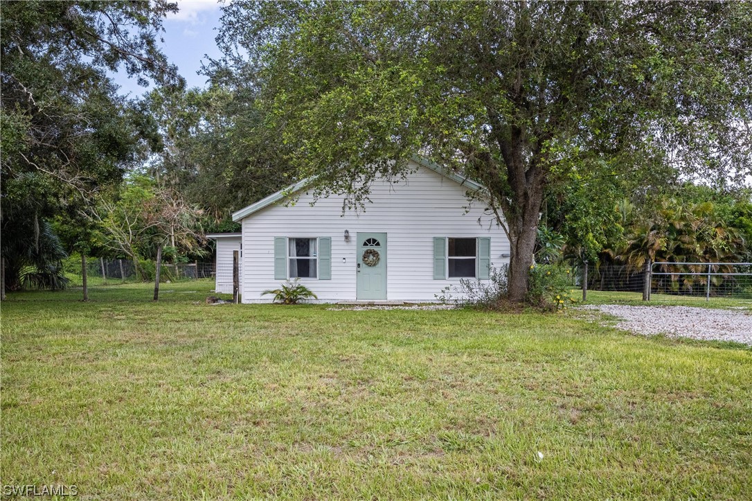 2701 Packinghouse Road Alva, FL 33920 - Photo 1 of 33 a view of a yard in front of a house with large trees
